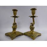 A pair of late 19thC ornately cast brass candlesticks,