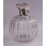 A flute cut spherical glass cologne bottle with a ground stopper,