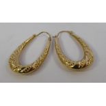 A pair of 9ct gold embossed oval hoop earrings