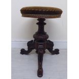 A late Victorian walnut framed music stool, the circular,