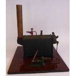 An early 20thC black and green painted iron and copper live steam model,