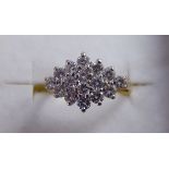 A gold coloured metal claw set diamond cluster ring