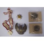 Five military belt buckles, helmet plates and medals,