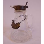 A glass whisky tot of conical form with a star cut base, silver collar,