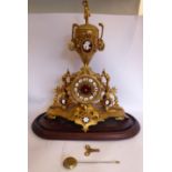 A modern reproduction of a late 19thC French gilded metal cased mantel clock,