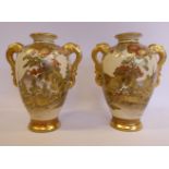 A pair of 20thC Satsuma gilded earthenware baluster shaped vases with opposing, moulded handles,