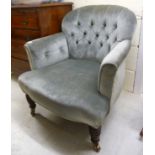 An Edwardian nursing chair, the part button upholstered back,