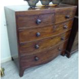 An early 19thC satinwood string inlaid mahogany bow front dressing chest with two short/three
