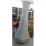 A floorstanding 'statement' lamp, featuring a tapered, vase design frame, clad in pleated,