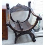 An early 20thC Italianate mahogany framed chair with a foliate scroll carved crest and demonic