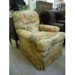 A modern armchair with a level back and scrolled arms,