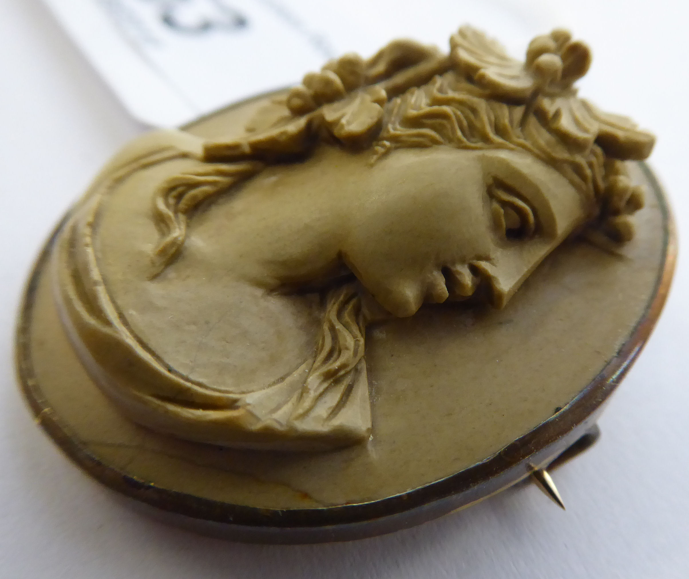 A late 19thC oval, yellow metal framed carved hardstone profile cameo portrait brooch, - Image 2 of 3