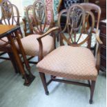 A set of six Regency inspired mahogany framed dining chairs with triple arched, carved and pierced,