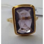 A gold coloured metal amethyst set dress ring 11