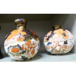 A pair of Derby china spherical bottles, one having a stopper,