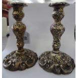 A pair of George IV loaded silver candlesticks,