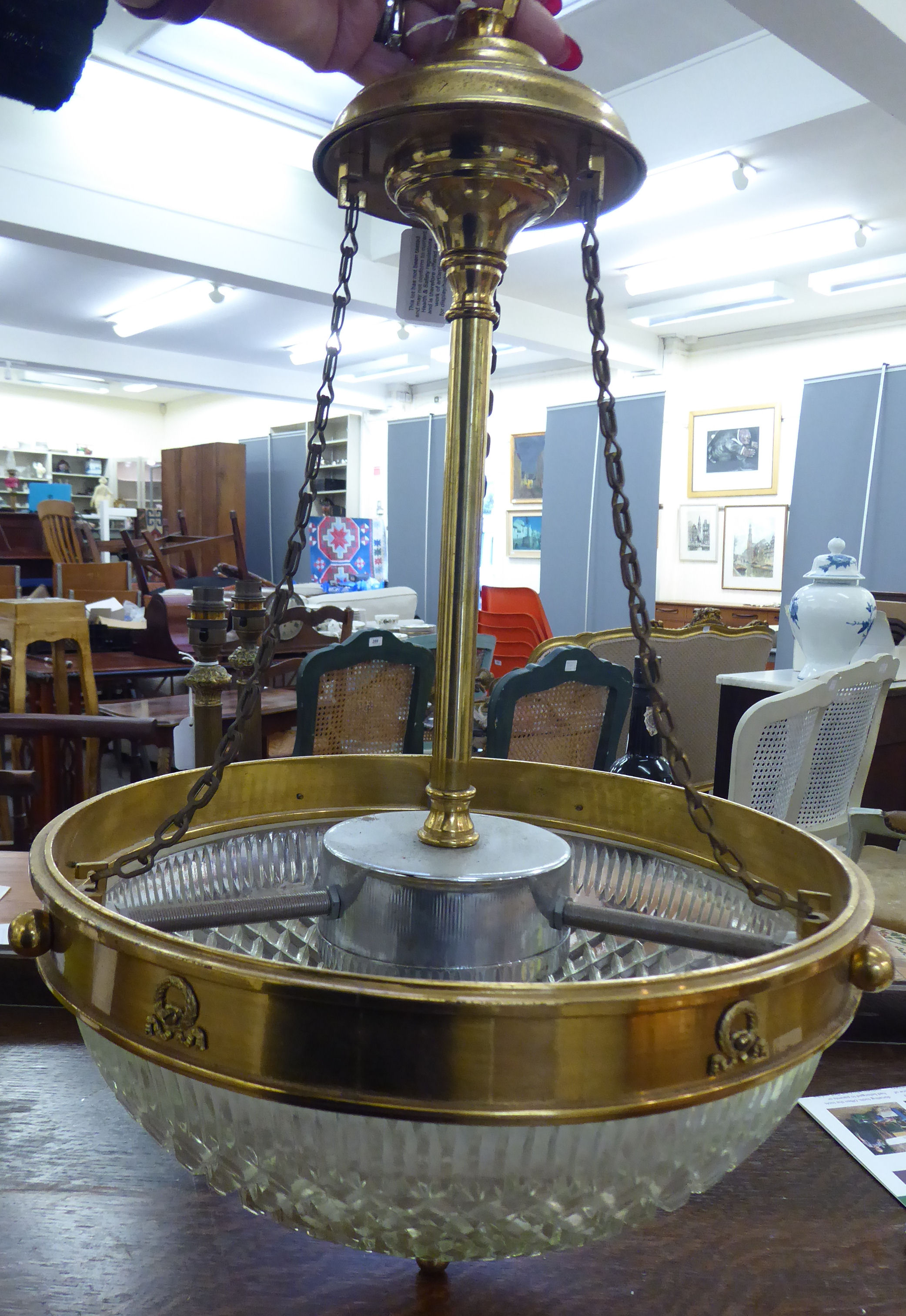 A mid 20thC lacquered brass framed centre light fitting with pendant chains and a moulded glass