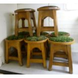 A set of eight mid 20thC oak framed bar room stools, the circular stud fabric upholstered seat,