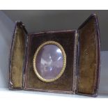 A late Victorian tooled and gilded brown hide cased travelling picture frame,