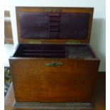 An early 20thC light oak, desktop stationery cabinet with a rising top, fall front,