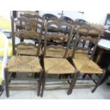 A set of six early 20thC stained beech framed Lancashire ladderback style dining chairs,