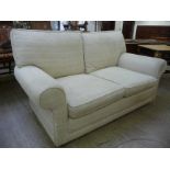 A modern two seater settee, upholstered in textured two tone cream coloured fabric,