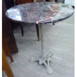 A mid 20thC terrace table, the mottled,