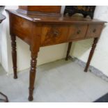 A mid Victorian mahogany side table with three frieze drawers, raised on ring turned,