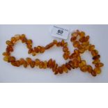 An irregularly shaped amber coloured bead necklace,
