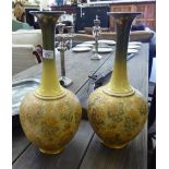 A pair of Royal Doulton misted green and yellow glazed stoneware bulbous bottle vases, having long,