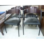 A set of four 1970s chairs, the curved stained teak bar backs on black painted metal frames,