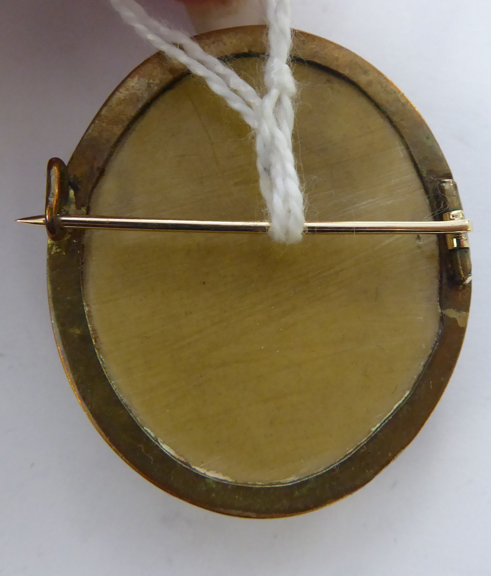A late 19thC oval, yellow metal framed carved hardstone profile cameo portrait brooch, - Image 3 of 3