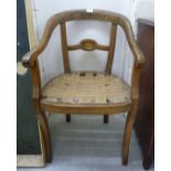 An early 20thC Continental bleached mahogany round back chair frame with open arms and a horizontal