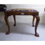 A 1930s walnut framed stool with a tapestry upholstered top,