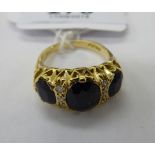 An 18ct gold claw set sapphire and diamond ring 11