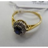 An 18ct gold ring, claw set with a central sapphire,