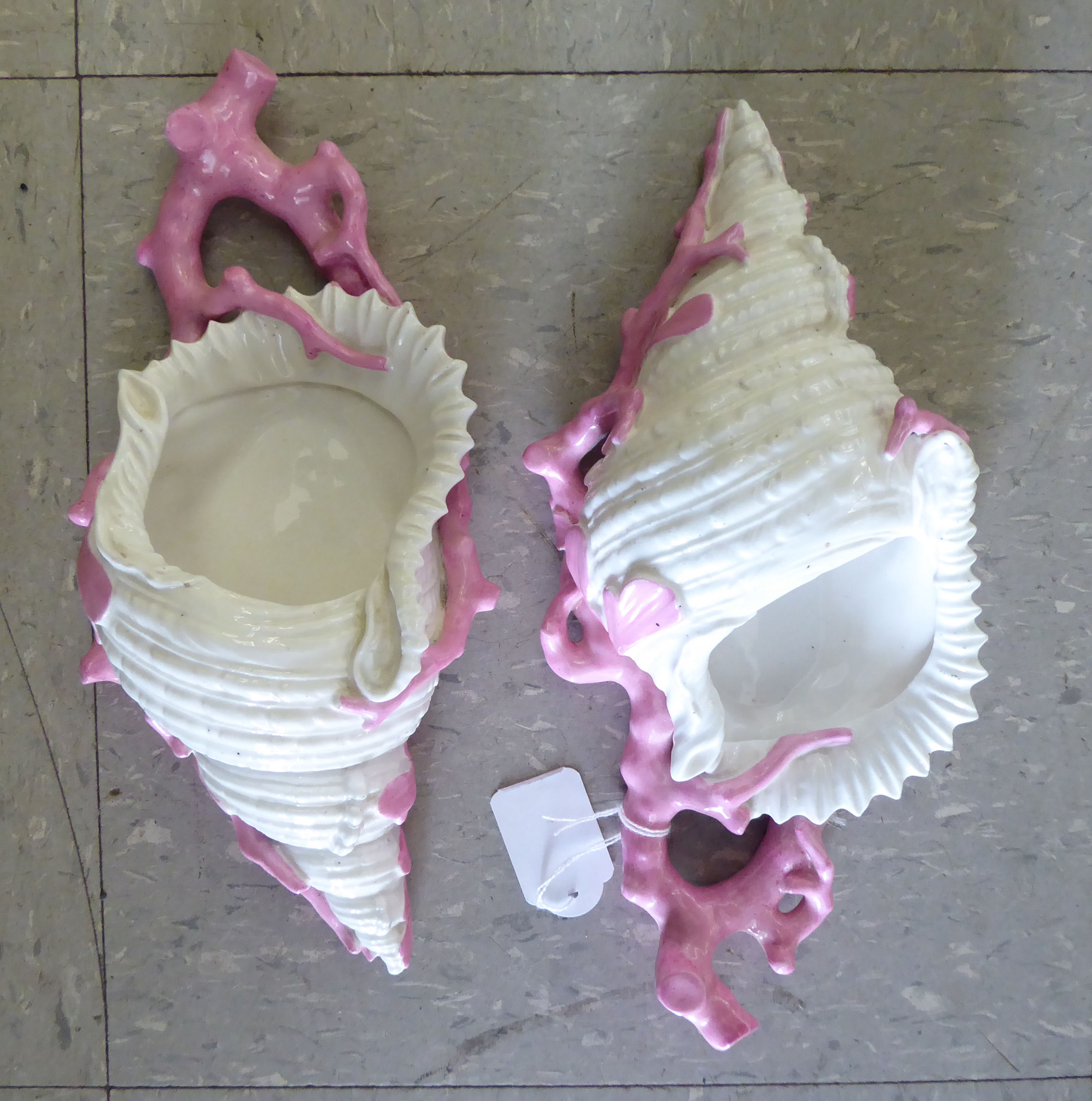 A pair of late Victorian naturalistically moulded ivory coloured and pink glazed porcelain,