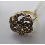 An 18ct gold diamond set ring of freeform 11