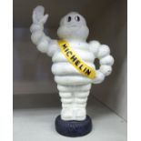 A cast iron model, Michelin Man standing on a tyre 7.