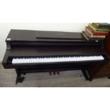 A Yamaha Clavinova mahogany cased electric piano 34''h 53''w RAB