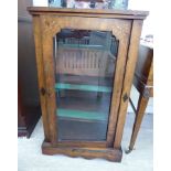 An Edwardian string inlaid mahogany pier cabinet with a single glazed door,