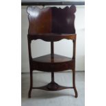 A George III mahogany quadrant washstand with two shelves and a single drawer, raised on splayed,