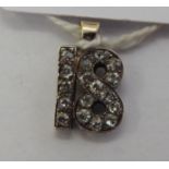 An early 20thC yellow metal diamond set pendant '18' 11