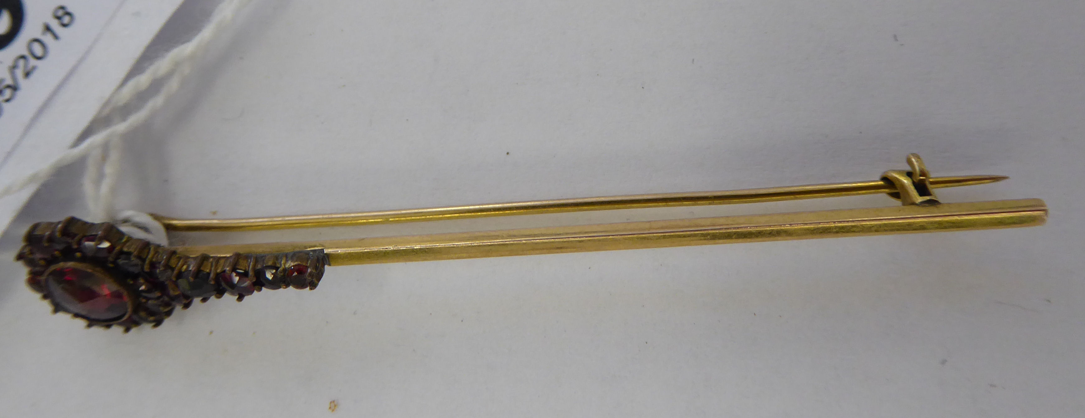 An 'antique' gold coloured metal bar brooch,