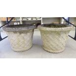 A pair of composition stone garden planters with basketweave decoration 18''h 24''dia SL