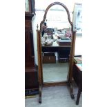 A 20thC Queen Anne style walnut and gilt painted cheval mirror,
