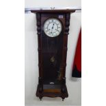 An early 20thC glazed mahogany cased Vienna wall clock with turned pilasters and drop finials;