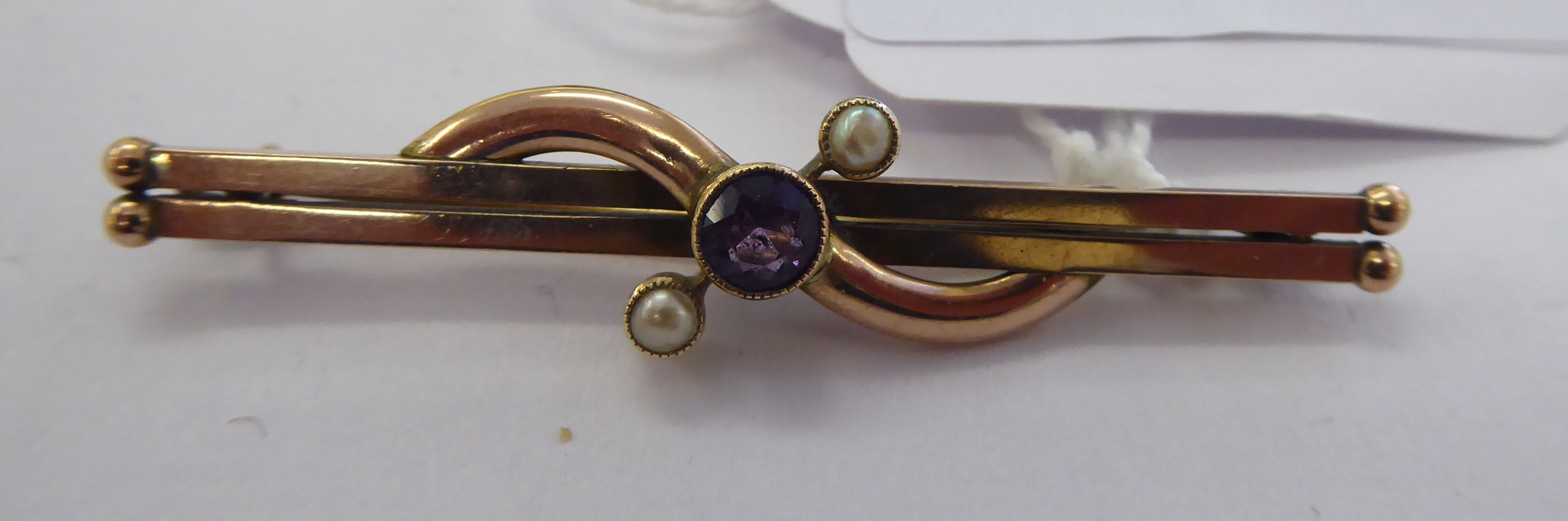 An 'antique' gold coloured metal amethyst and seed pearl set bar brooch 11