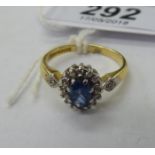 An 18ct gold claw set sapphire and diamond cluster ring 11