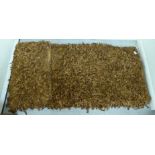 A 'vintage' brown tasselled hide rug 66'' x 64'' SR